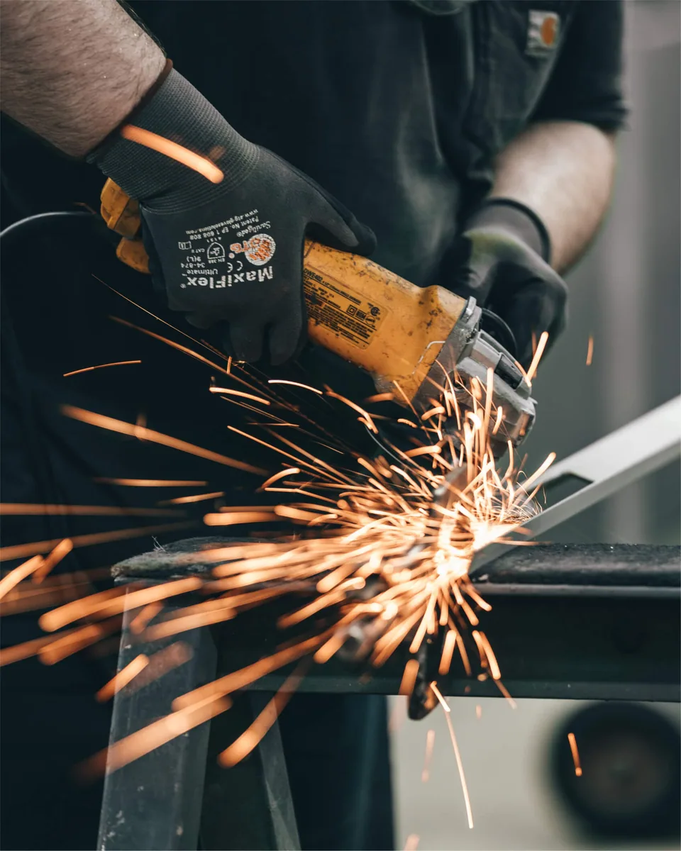 A man cutting a kind of metal.